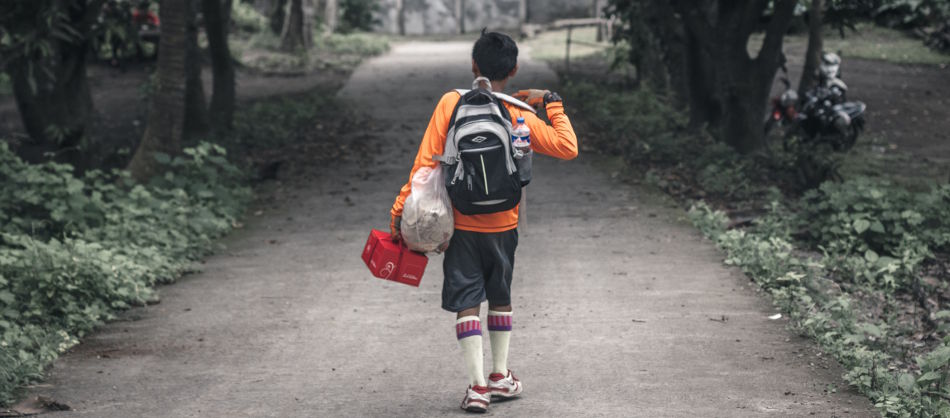 boy walking with backpack